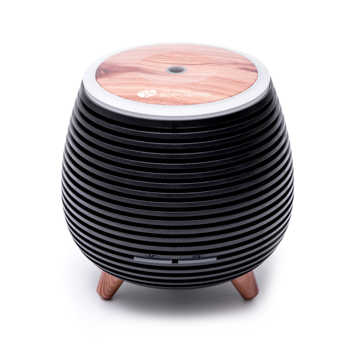 The ZOEY Aroma Diffuser, Humidifier & Night-Light by Rio features a black, round, ribbed design with wooden legs and a wood grain top—ideal for calming your space. Shown here on a white background.