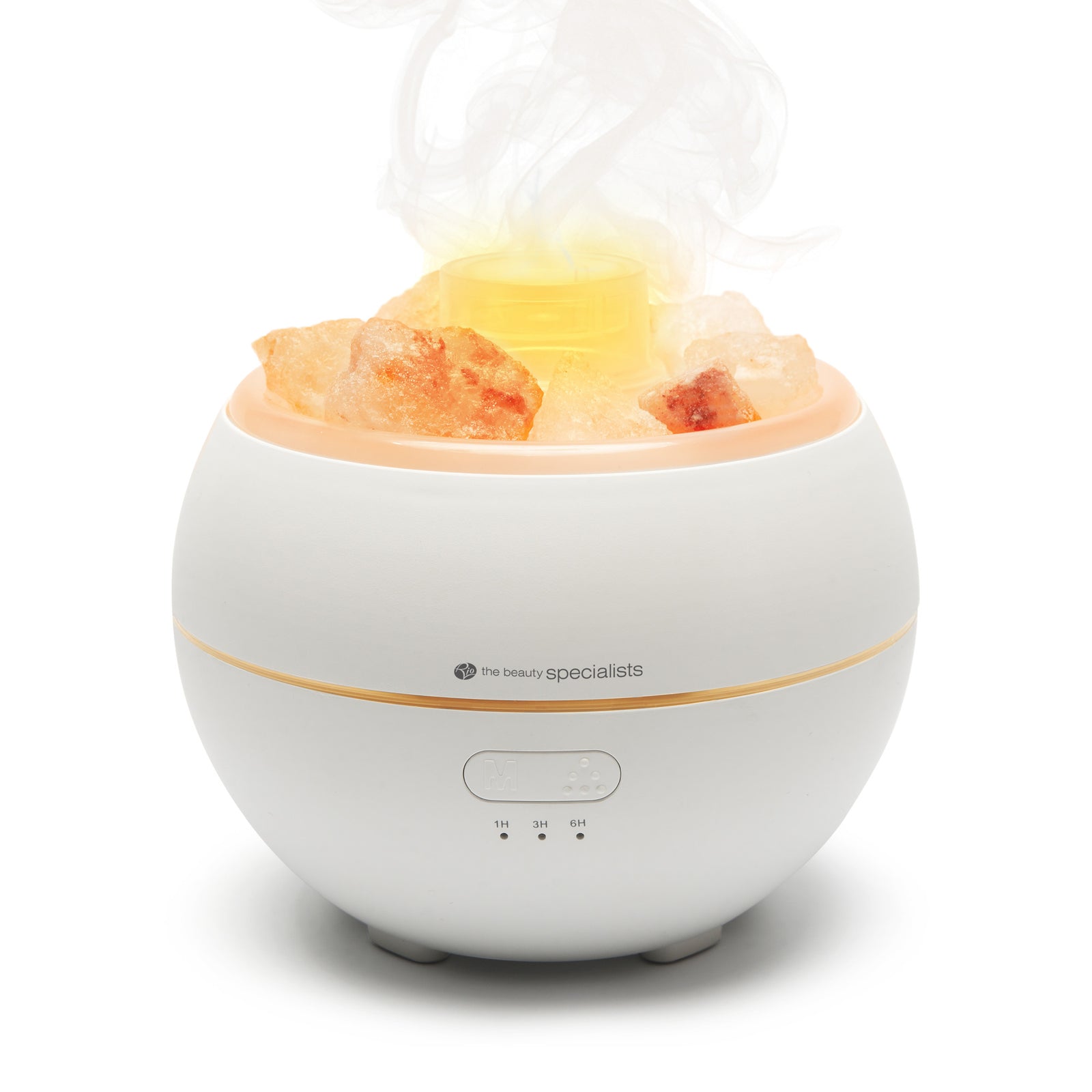 The Rio Aroma Diffuser, Humidifier & Night-Light with Himalayan Rock Salt emits mist and a soft yellow glow, featuring control buttons on the front and Himalayan rock salt rocks atop its round white design.
