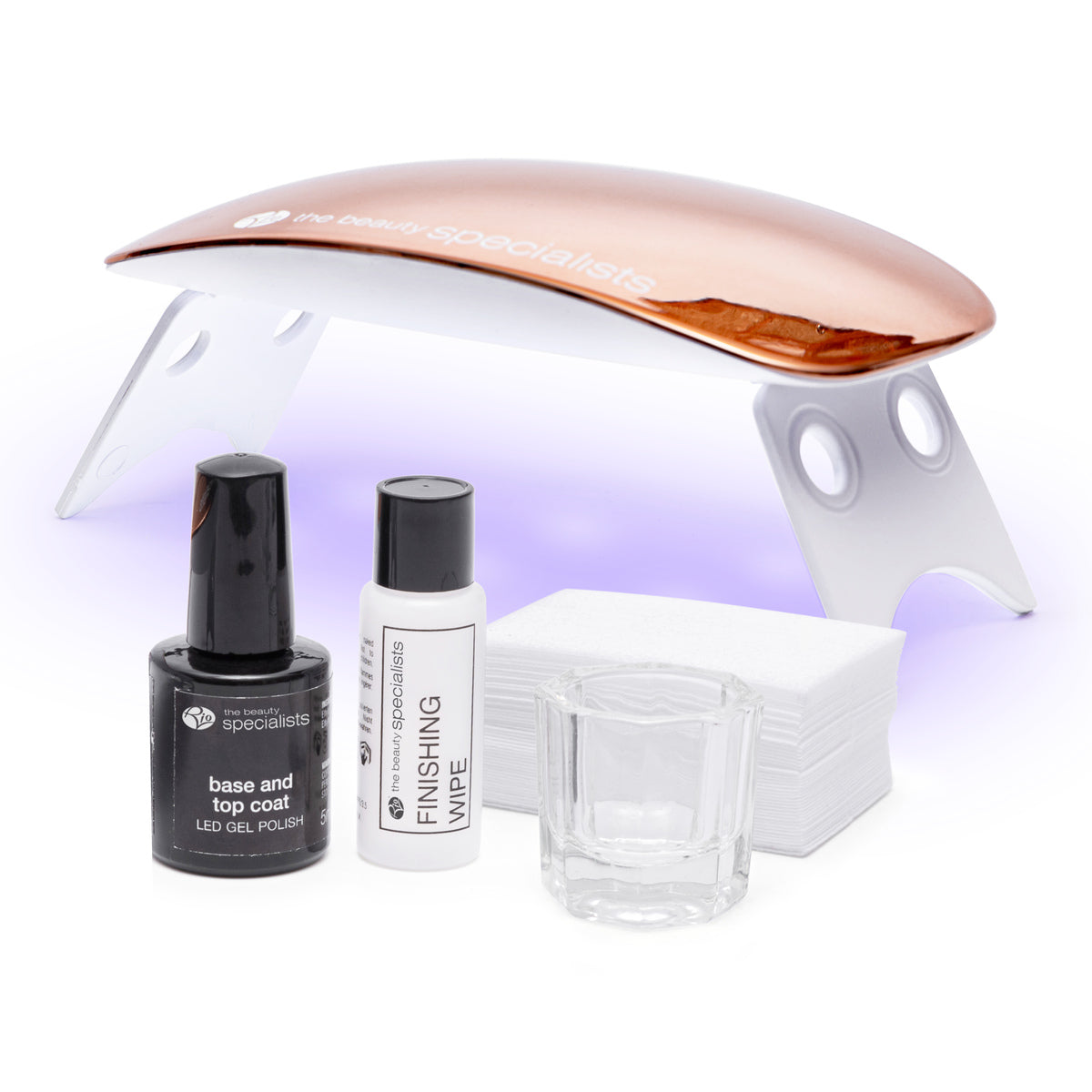 The Rio 14 Day Gel Polish Nails kit includes a rose gold LED lamp, base and top coat gel polish, finishing wipe, clear glass container, and white nail wipes—everything you need for long-lasting shine on a white background.