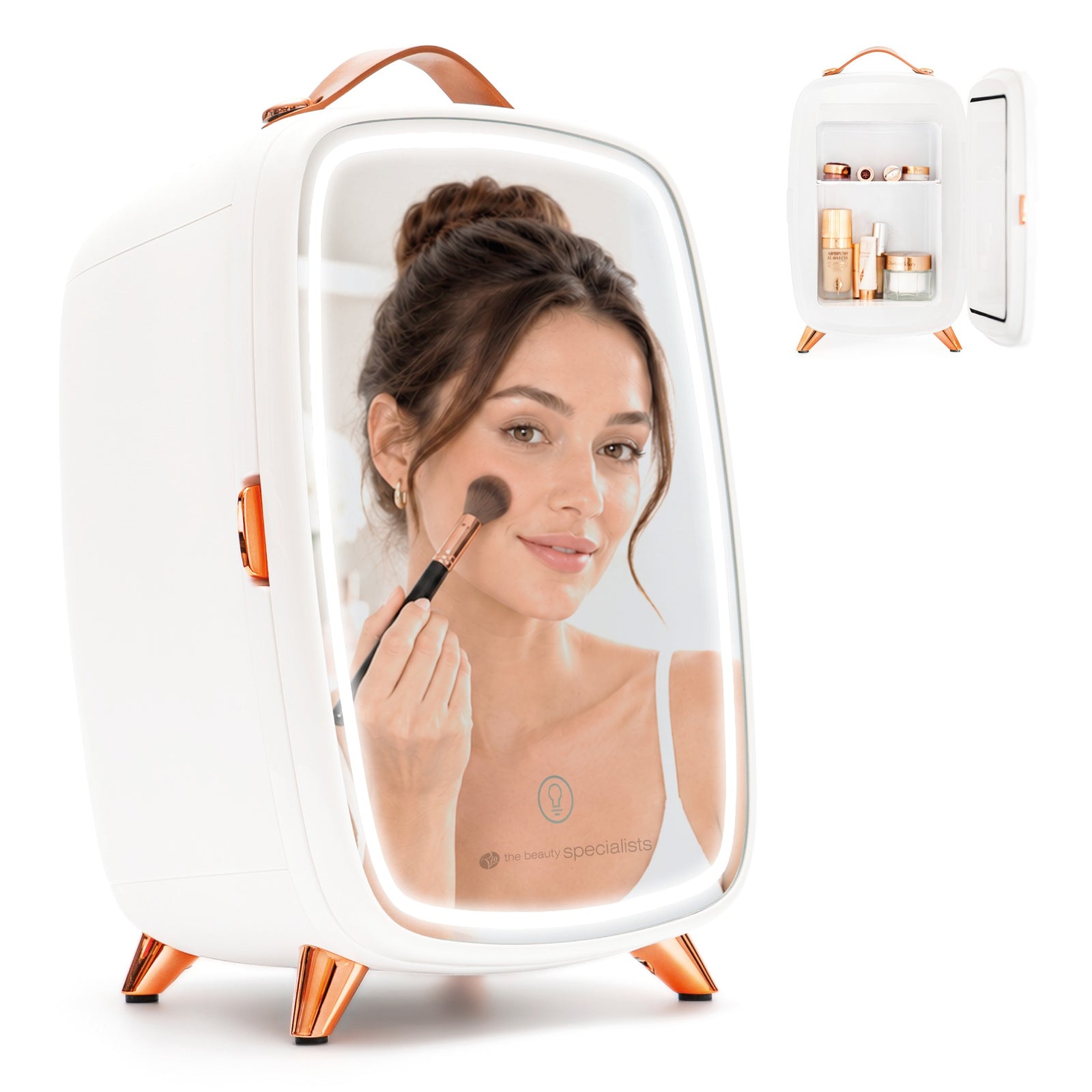 A woman applies makeup with a brush, her reflection visible in the Rio Beauty Skincare Fridge With Mirror, which features stylish rose gold accents. An inset shows that the mirror doubles as a chilled storage fridge for creams and cosmetics.