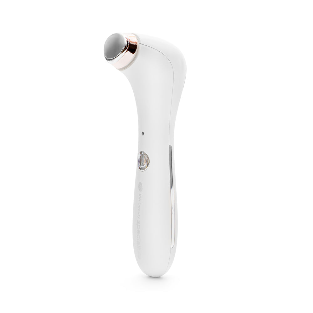 The Rio Eye Refreshing Massager features a white body with a metallic oval head, rose gold accents, a front button, and LED indicator. Designed to reduce puffiness and dark circles, it stands upright against a white background.