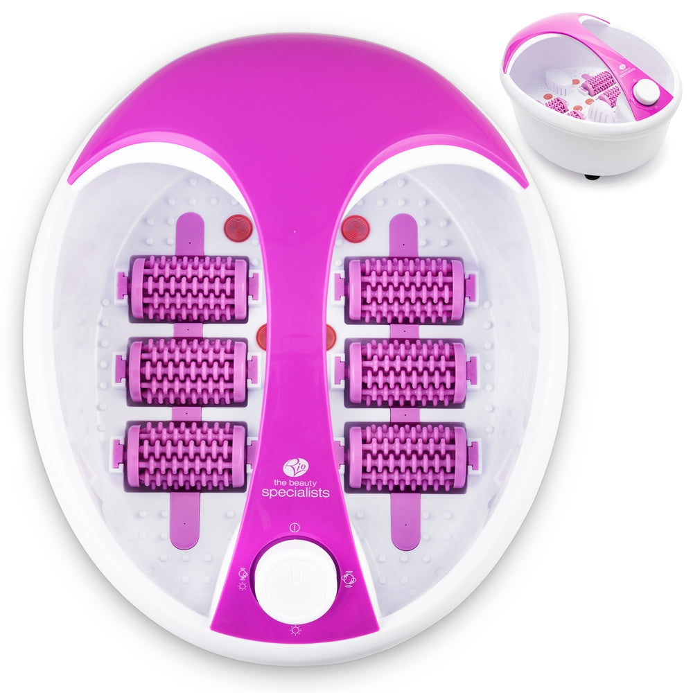 A purple Deluxe Foot Spa Bath and Massager by Rio with four massage rollers and control settings. The device features the Rio logo. An inset shows the spa filled with water and accessories.