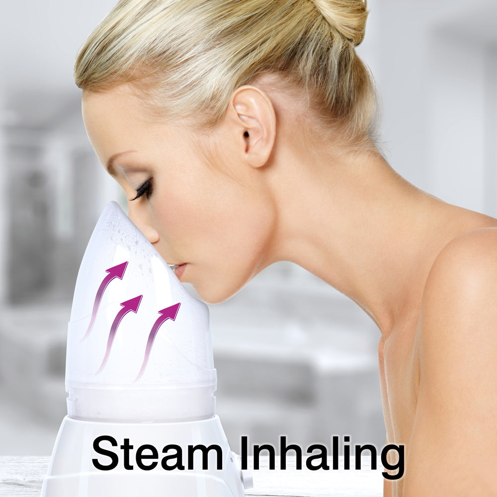 A woman uses the Rio Facial Sauna Skincare with Steam Inhaler as steam rises toward her face. The blurred background and “Steam Inhaling” text at the bottom highlight the benefits of this facial sauna.