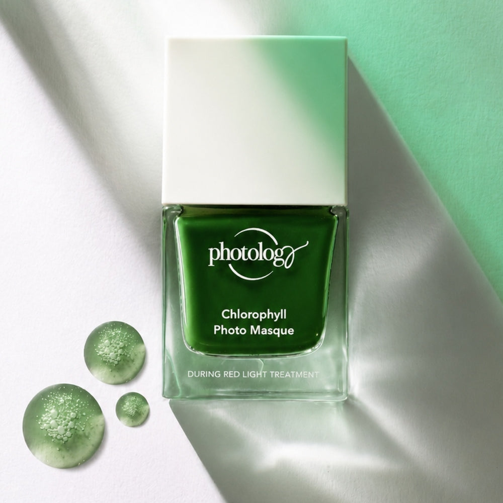 A square glass bottle labeled Rio Photology Chlorophyll Light Serum Masque sits on a white surface, casting a green shadow. Two drops of green gel with bubbles are beside the bottle, highlighting skin elasticity like LED masks.