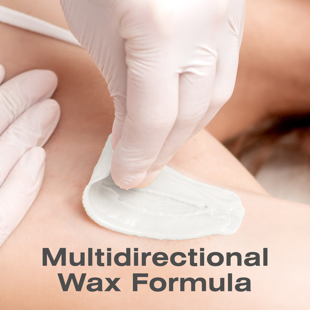 A gloved hand removes Rio Coconut Go Smooth Stripless Hard Wax Beads (100g) from skin, demonstrating a waxing process for smooth results. The text Multidirectional Wax Formula appears at the bottom of the image.