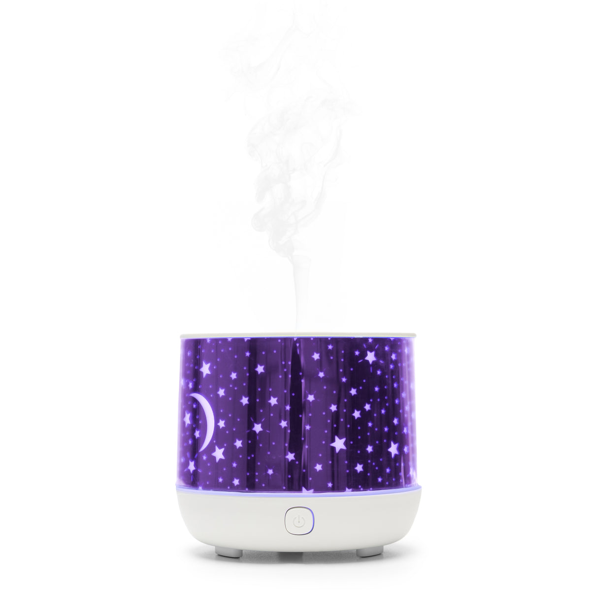 The Rio Dream Time Aroma Diffuser, Humidifier, and Night Light features a purple night sky design with stars and a crescent moon, emits visible mist from the top, and has a round white base with a front power button.