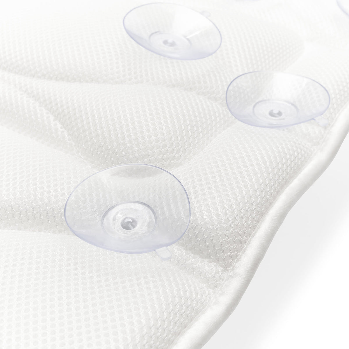 Close-up of the Rio Luxury Bath Mat & Pillow in white, featuring three clear suction cups for secure grip, shown on a white surface.