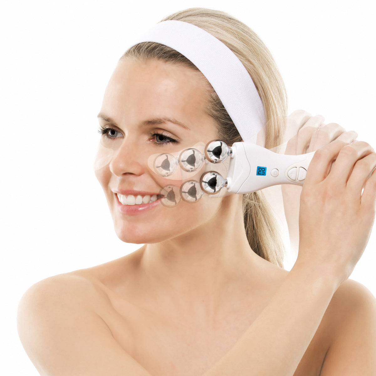 A smiling woman with a white headband uses the Rio Lift Plus 60 Second Face Lift, a handheld facial massager with rotating metal spheres, demonstrating face rejuvenation against a white background.