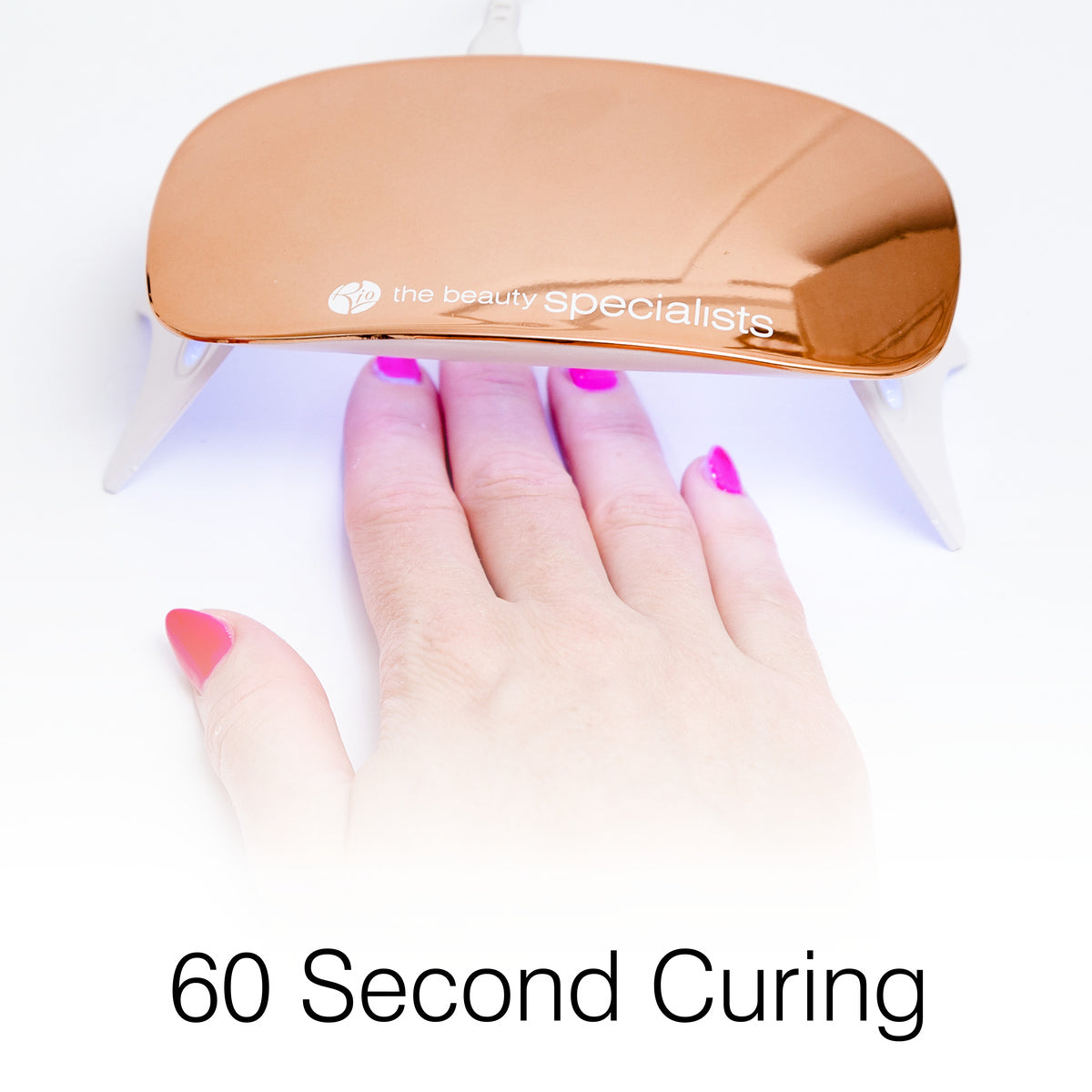 A hand showcases Rio 14 Day Gel Polish Nails in pink, placed under a rose gold nail lamp with the beauty specialists logo, highlighting professional LED curing for long-lasting shine. The text below reads 60 Second Curing.