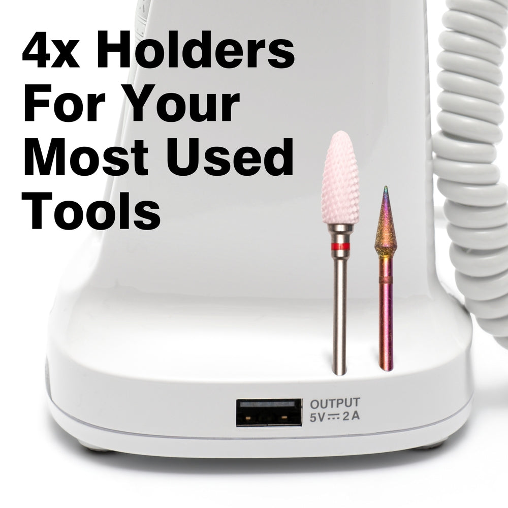 The Rio Salon Pro Electric Nail File & Drill is a white device with two drill bits in holders, a USB output port below, and “4x Holders For Your Most Used Tools” in bold on the left. A coiled cord appears on the right—ideal for DIY nail care.