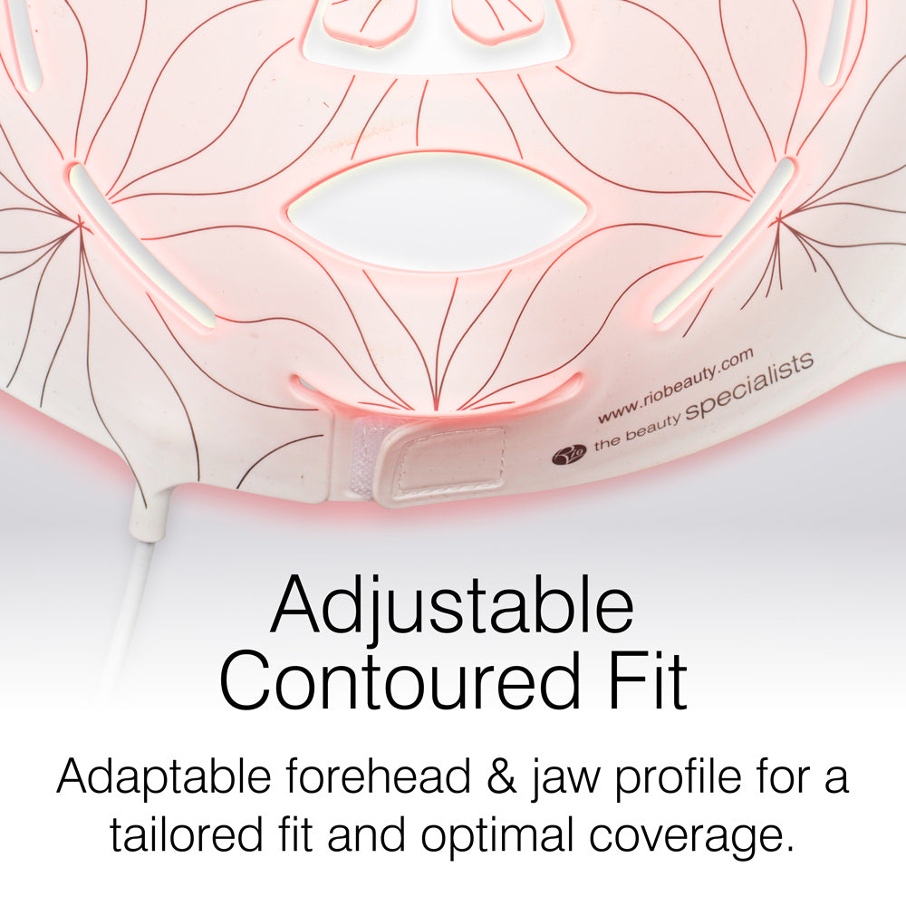 Close-up of the Rio FaceGLO mask shows its floral line pattern, glowing red light, and eye, nose, and mouth cut-outs. Text overlay highlights an adjustable contoured fit and clinically effective wavelengths for full-face coverage.