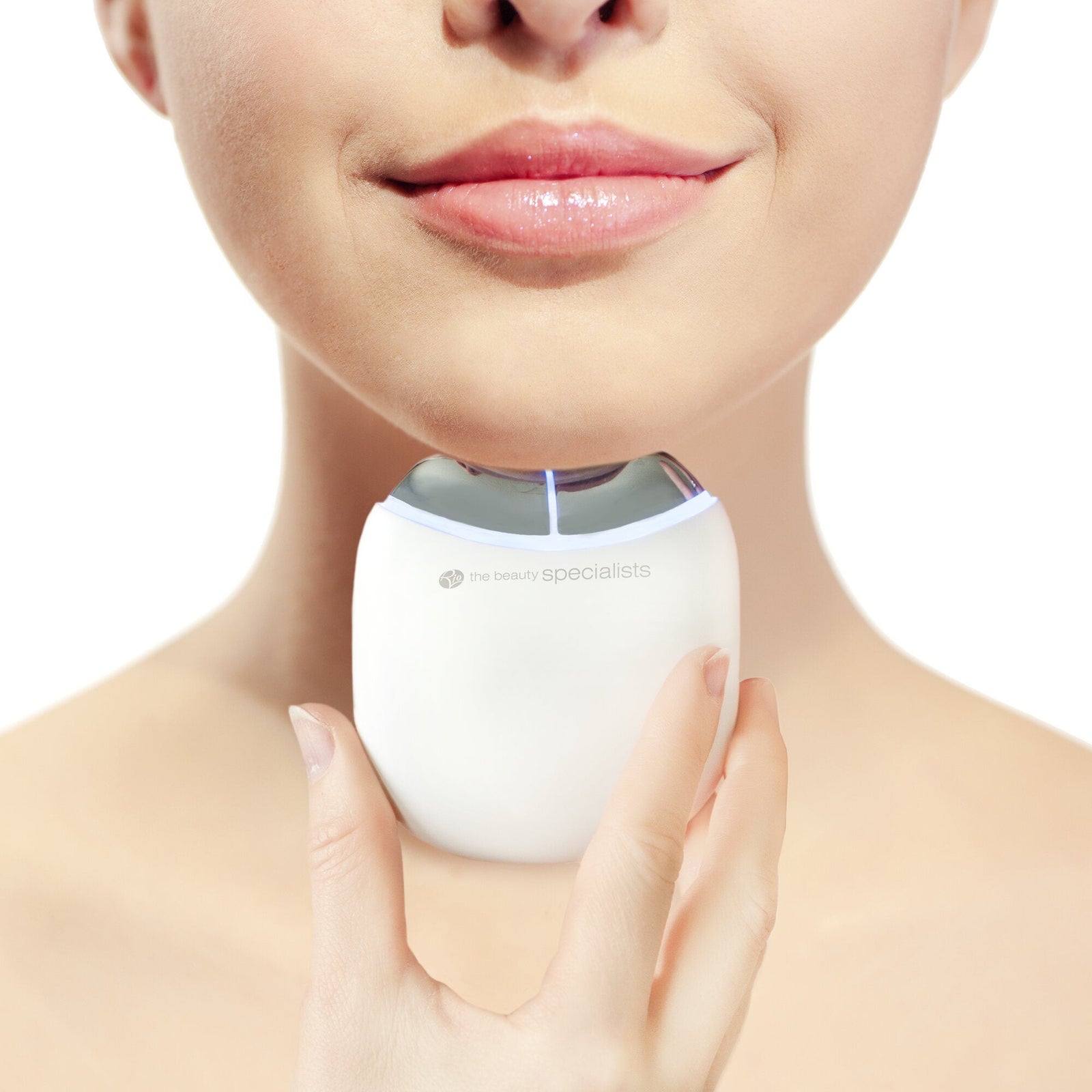 A woman smiles gently, holding the Rio Face Lift & Tone Facial Toner with a metallic top beneath her chin. The white background highlights the lower half of her face and the skin toning device.