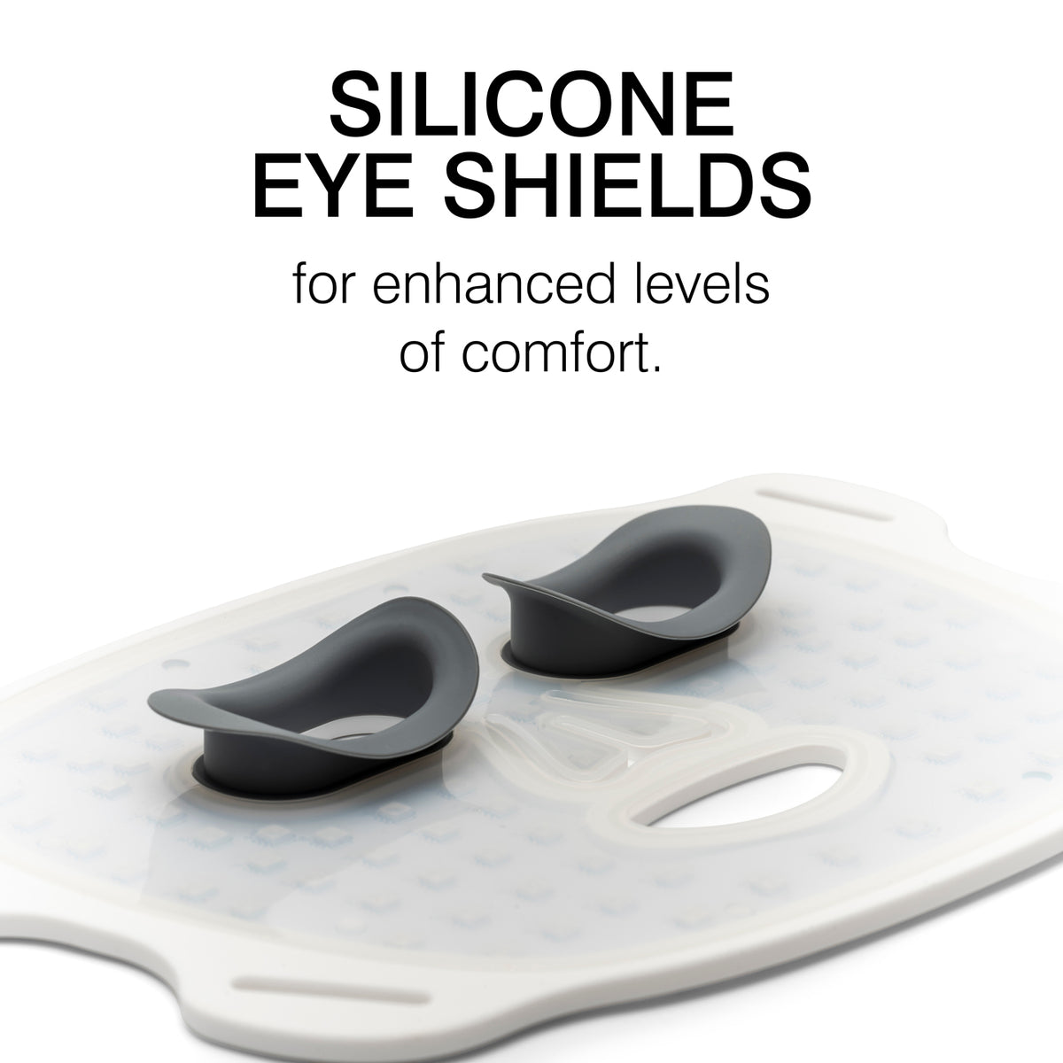 Two black silicone eye shields rest on a white textured surface, with the text: Silicone Eye Shields for added comfort—perfect for Rio LED Face Mask light therapy or anti-ageing treatments by Rio.