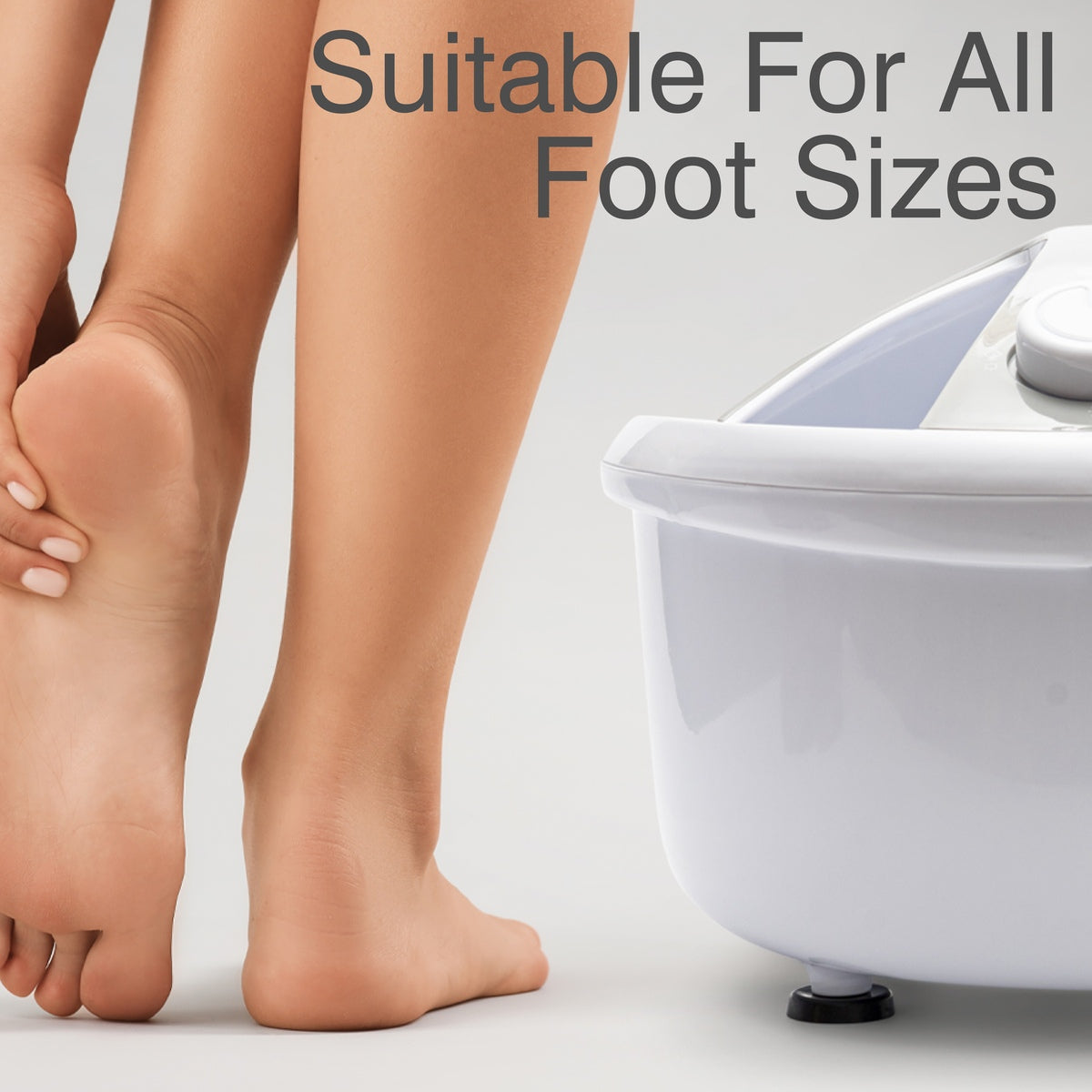 A person stands next to a white Rio Deluxe Foot Spa Bath and Massager, holding one foot with their hand. The text reads, Suitable For All Foot Sizes.
