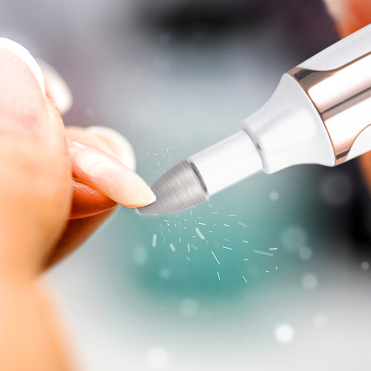 A close-up shows someone using the Rio Precision Pro Electric Nail File on their fingernail, with fine nail particles in the air—highlighting precise nail care against a softly blurred background.