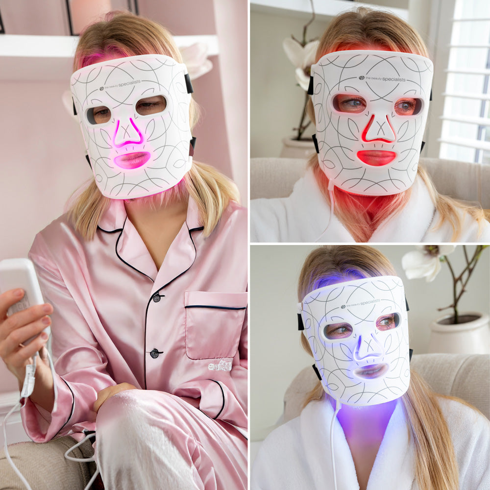 Three images show a woman relaxing indoors in pajamas and a robe using the Rio LED Face Mask by Rio, which glows pink, red, and blue. She appears to control the anti-ageing light therapy mask with a remote.