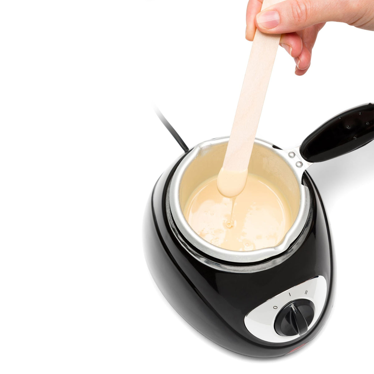 Total body wax pot with melted wax in and person dipping spatula in the melted wax