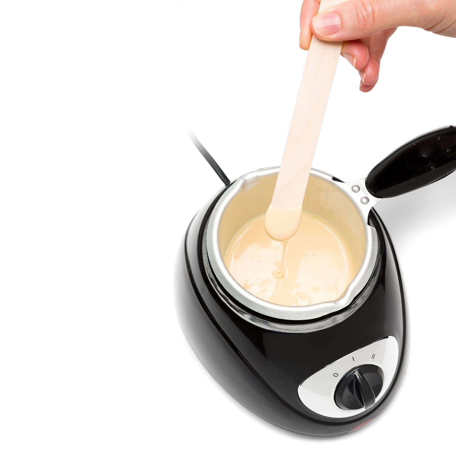 Total body wax pot with melted wax in and person dipping spatula in the melted wax