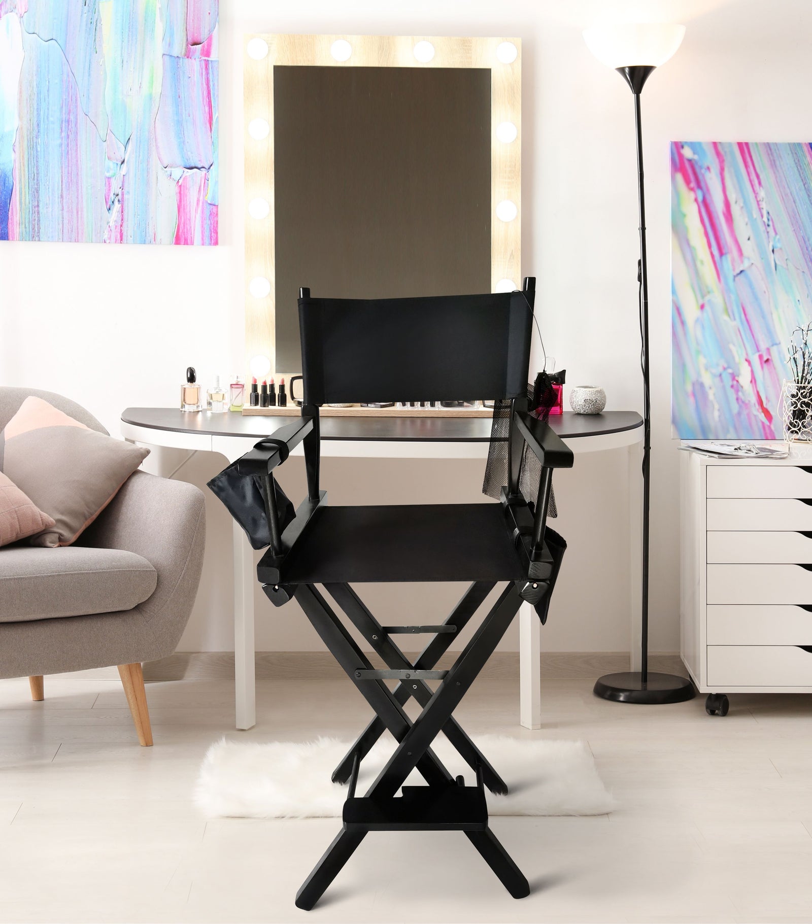 professional make up artists chair in bedroom setting in front of dressing table and mirror with make up and cosmetics 