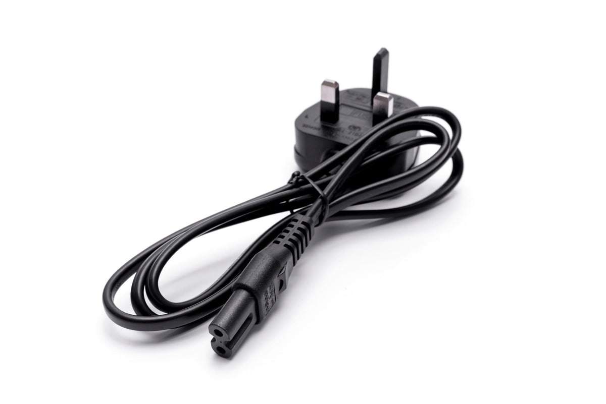 A black UK three-pin power plug with attached cable, designed for the Rio PROFESSIONAL MAKEUP &amp; VLOGGING 18-INCH DIMMABLE LED RING LIGHT ADAPTOR, is coiled neatly on a white background.