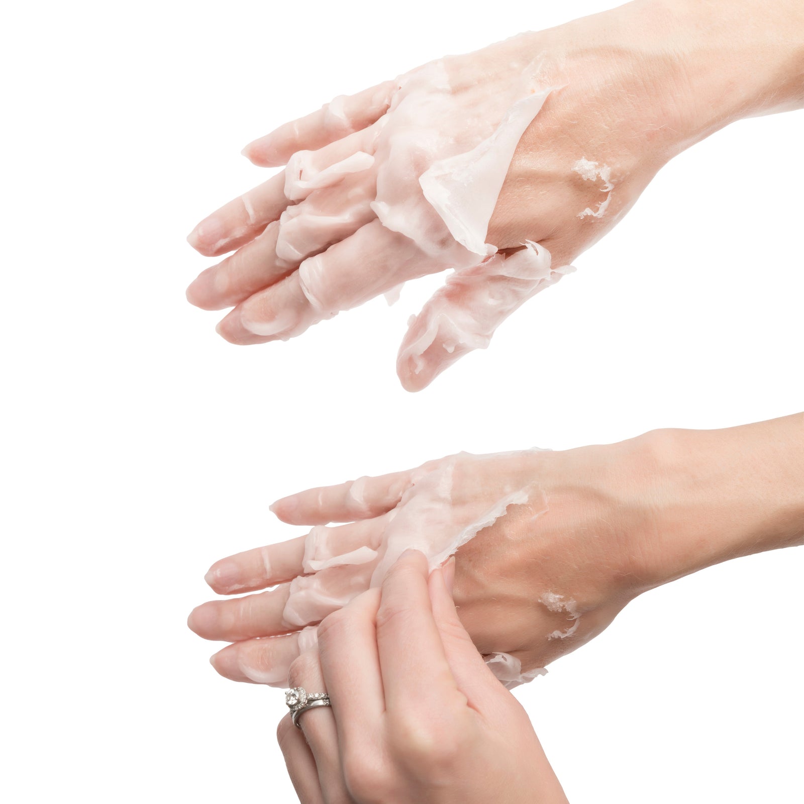 Two hands with a white wax mask being peeled off the skin; one hand pulls the dried layer from the back of the other, demonstrating comfort and enhanced hydration using the Rio Paraffin Wax Heater.