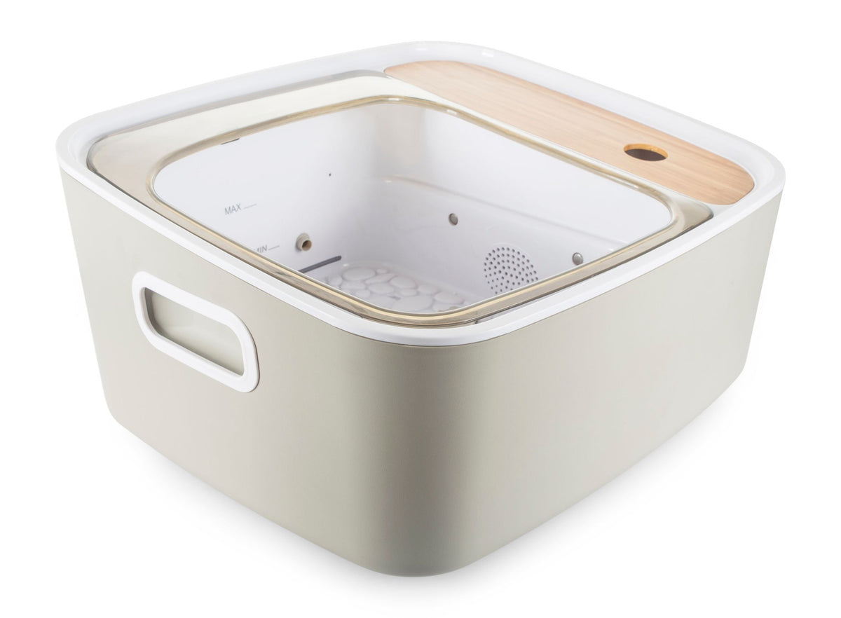 side view of Scandinavian jacuzzi foot spa empty with view inside of pebble base and hydrojets 