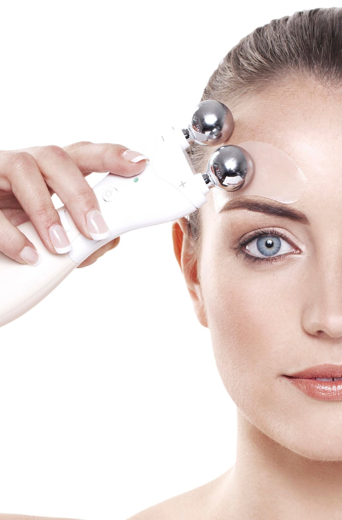 close up of a ladies face wearing collagen and retinol patch above eyebrow and using Rio 60 second face lift on temple area