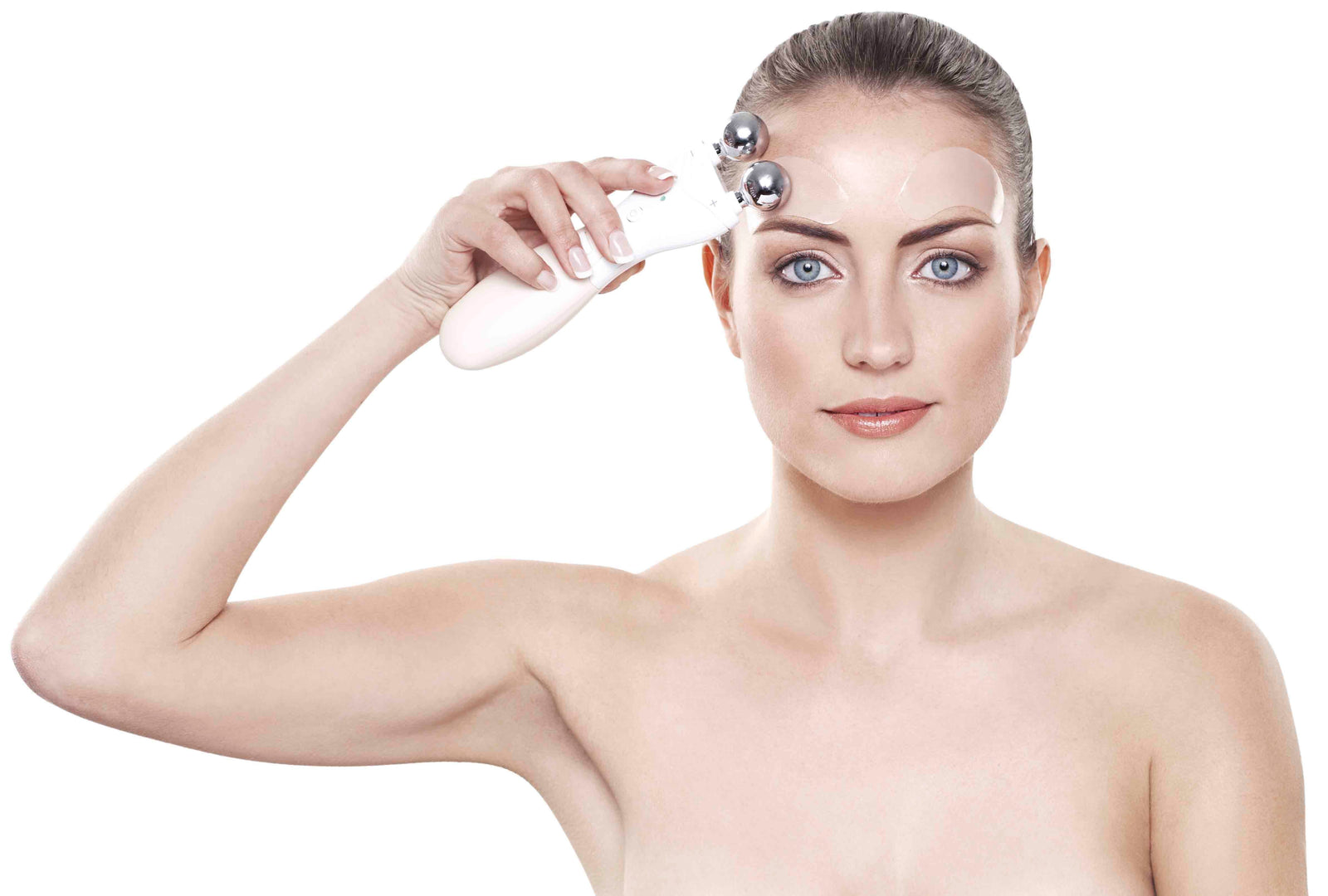 brunette lady wearing collagen and retinol patches above her eyebrows using rio 60 second face lift pastel pink hand set to treat temple area 