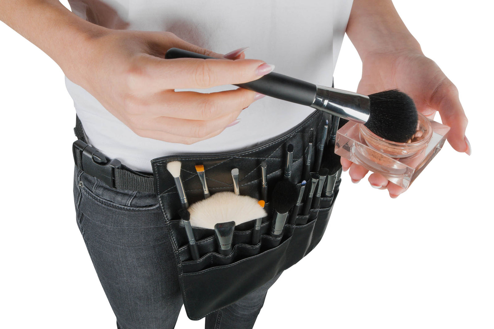 A person holds a makeup brush and a loose powder container, wearing the Rio PROFESSIONAL SALON MAKEUP BRUSH COLLECTION & BELT equipped with 24 salon-quality brushes.