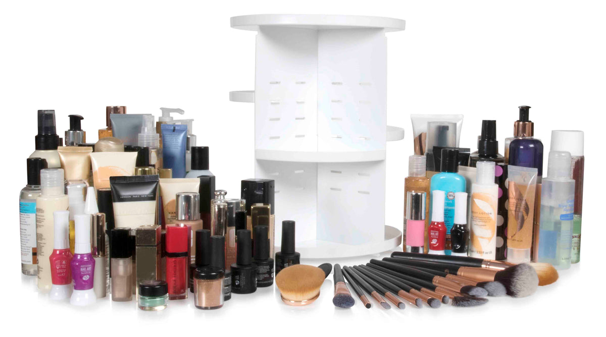 The Rio Cosmetic & Brush Storage Carousel is surrounded by bottles, tubes, nail polishes, brushes, and cosmetic containers on a white background for easy access and stylish beauty storage.