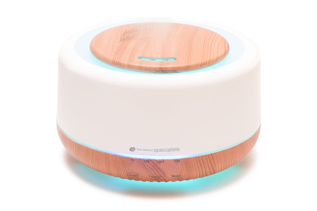 The Rio ALORA Aroma Diffuser is a round, modern device with a white and wood-grain look. It functions as a humidifier and night-light, featuring front buttons and indicator lights to enhance your space with soothing scents and balanced moisture.