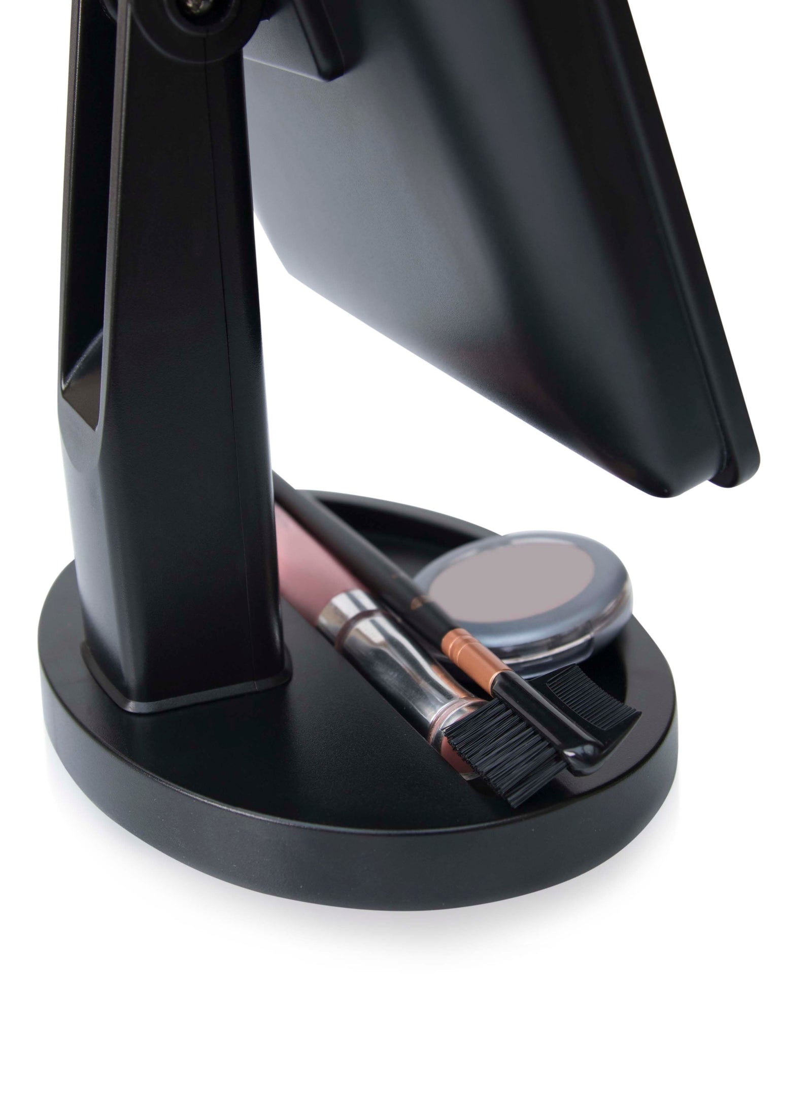 close up of base of mirror with built in cosmetic storage tray with make up stored inside 